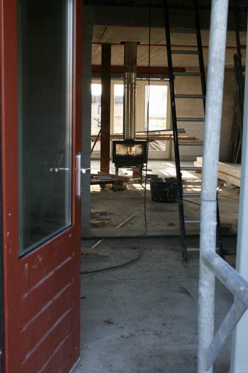 resize-of-marco-kooi-1-07112008 In de nieuwbouwwoning van de familie Kooi brandt de kachel. Goed voor het binnenmilieu, en goed voor maker Marco en zijn assistenten, als ze binnen bezig zijn. Al het glas is inmiddels geplaatst, het begint steeds meer een (t)huis te worden.