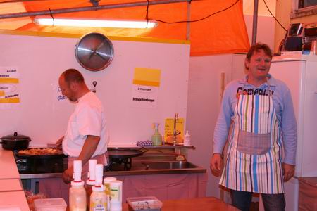Brood en Spelen ook tijdens de Noordhorner Feestweek, beter gezegd: Hamburgers en volleybal. Allround-bakker Harm Bos draait er zijn hand niet voor om, zijn gelegenheidsassistent Henk Koets evenmin... 