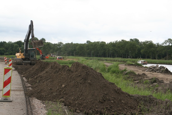 Op de voorgrond nieuwe grond om de toekomstige kanaaloever te versterken; op de achtergrond wordt grond afgegraven ter verbreding van het Van Starkenborghkanaal