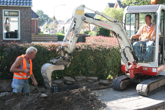 De machinale schraper in actie, de handwerker vult aan....