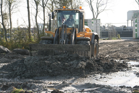 Tegelijkertijd is op deze werkplek een forse tractor bezig een hoop bagger te verschuiven. Waar dat vandaan komt? Zal ook nog wel worden afgevoerd....